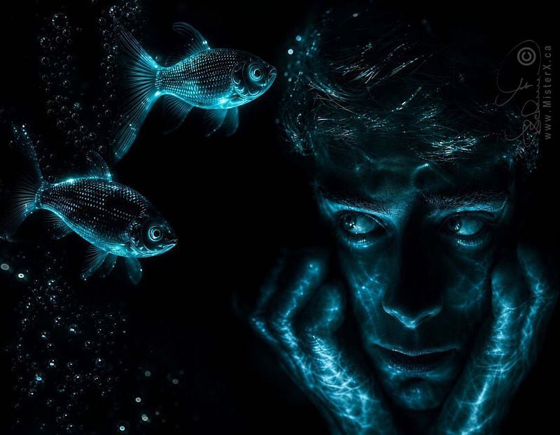 This digital artwork features a man's face and hands resting on his chin, illuminated by an ethereal, shimmering blue light that mimics underwater reflections against a dark, pitch-black background. To the left, two glowing goldfish swim amidst small bubbles, their scales and fins detailed with the same electric blue luminescence. The overall composition creates a surreal, deep-sea atmosphere, emphasized by the dramatic contrast between the intense highlights and the shadows.
