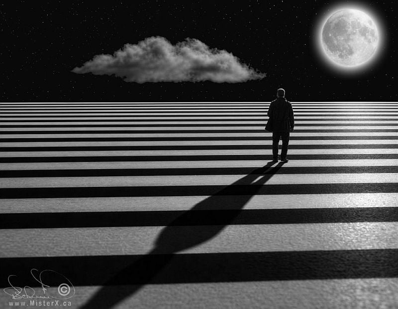 This black-and-white digital composite depicts a lone individual standing on a surreal landscape defined by alternating wide horizontal black and white stripes that stretch to a flat horizon. The person, viewed from behind, casts a long, distorted shadow forward into the foreground across the striped ground. Above the horizon lies a dark, starry night sky featuring a single, elongated cloud floating to the left and a large, glowing full moon positioned on the right.